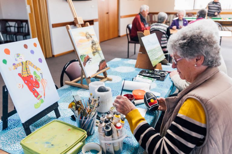 Lady painting in village centre