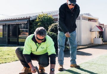 mbl-villages-maintenance Maintenance staff and resident fixing pathway